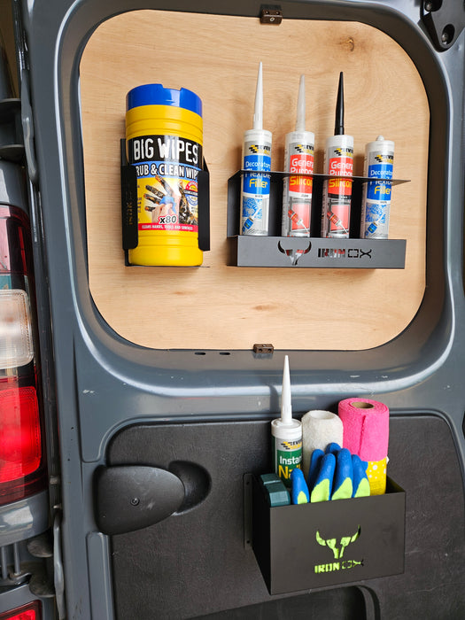 A van door with a sleek design features a Wipe Dispenser Holder, three tubes of sealant, a caulking gun, and a container with cleaning sponges and rolls of paper towels. The universal fit ensures seamless organization on any model.