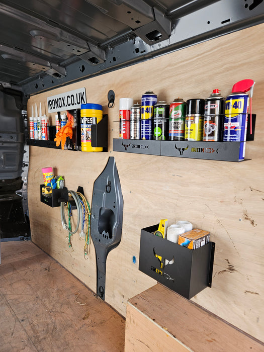 The interior of a work van showcases van accessories with space-saving storage solutions, including the General Purpose Metal Storage Box - Large, tools, spray cans, and cleaning supplies neatly arranged on wall-mounted shelves and holders.