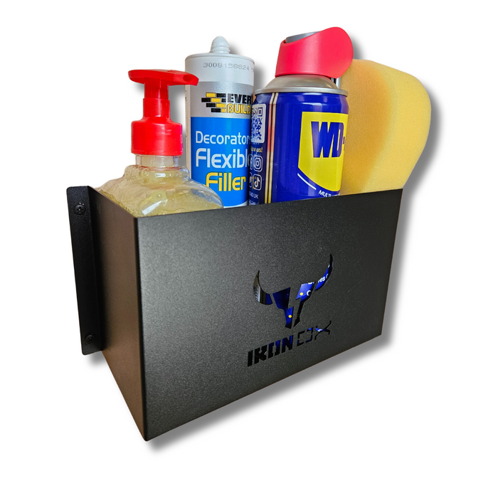 A black wall-mounted shelf, perfect for van accessories, holds a General Purpose Metal Storage Box - Medium, a hand soap pump, a can of flexible filler, a can of WD-40, and a sponge.